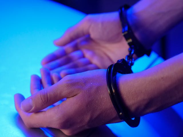 person with hands in handcuffs