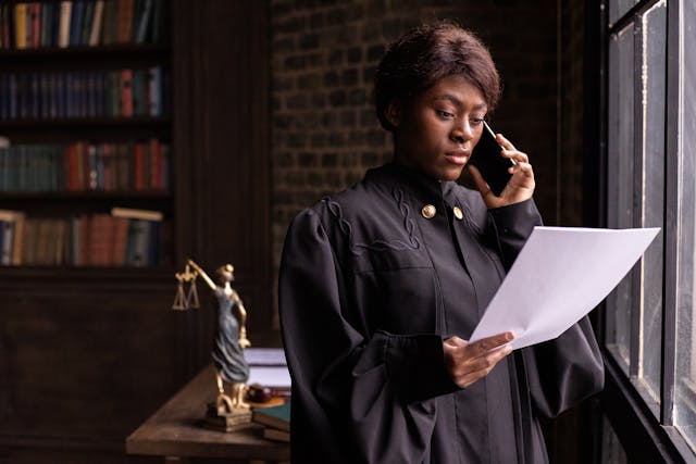 judge on phone holding paper