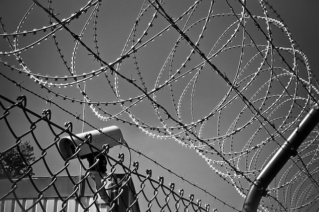 barbed wire and camera near fence